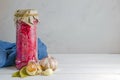 Fermented pickled vegetables. red cabbage with beets and bay leaves in a glass tall jar on a light background. copy space Royalty Free Stock Photo