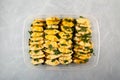 Fermented Pineapple slices with mint leaf in cane sugar syrup. Traditional Asian fruit salad in plastic container