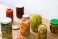 Fermented preserved vegetables in jar on wood
