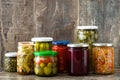 Fermented preserved vegetables in jar on wood