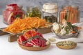 Fermented red hot peppers to enhance immunity with spices and grated carrots on a hand grater on a light wooden table Royalty Free Stock Photo