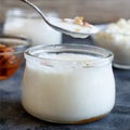 Fermented yogurt kefir in small bottles with cherries and walnuts