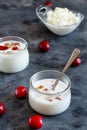 Fermented yogurt kefir in small bottles with cherries and walnuts