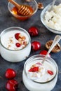 Fermented yogurt kefir in small bottles with cherries and walnuts