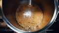 Fermenting of a beer in an open fermenters in a brewery.