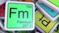 Fermium Fm block on the pile of periodic table of the chemical elements blocks. 3D rendering