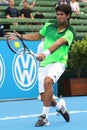 Fernando Verdasco makes ball contact with a high backhand