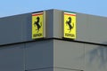 Ferrari cars logo on the building of an official dealer