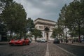 Ferrari driving by Arc de Triomphe Paris, France