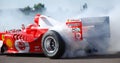 Ferrari F1 Michael Schumacher Donut Smoking Tyre at Fiorano Circuit, Italy. One Handed Driving with Wave During Donut.