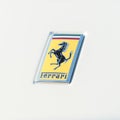 Ferrari logo on the luxury white supercar close up