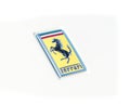Ferrari logo on the luxury white supercar close up