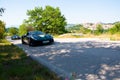 Ferrari 488 pistas driving um a hill on a sunny day