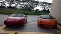 Red Ferrari and Sports orange car.