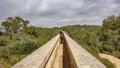 The Ferreres Aqueduct top view with tourist walking