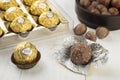 Ferrero Rocher chocolates and hazelnuts over wooden table