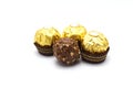 Ferrero Rocher is premium chocolate ball sweets filling with nuts and luxury delicious. Italian chocolate candies isolated on whit