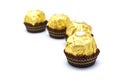 Ferrero Rocher is premium chocolate ball sweets filling with nuts and luxury delicious. Italian chocolate candies isolated on whit