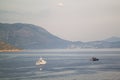 ferries carrying cars and people sailing at dusk in the waters o Royalty Free Stock Photo