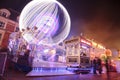 Ferris Whee and Visitors Walking Through Fun Fair in Banbury