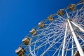 Ferris wheel against the blue sky in an amusement park