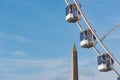 Ferris wheel against blue sky and la Concorde obelisk