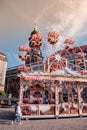 Ferris wheel at Altmarkt in morning. Kreuzkirche bellfry on background.