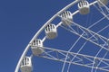 Ferris wheel amusement Park. White Ferris wheel on summer blue sky in Park.