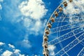 Ferris wheel on blue sky background with white clouds Royalty Free Stock Photo