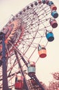 Big Ferris wheel. Bottom view. Toned vertical image in retro style.