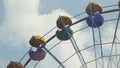 Ferris Wheel of bright color on blue sky background with white clouds Royalty Free Stock Photo