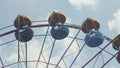 Ferris Wheel of bright color on blue sky background with white clouds Royalty Free Stock Photo
