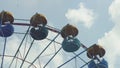 Ferris Wheel of bright color on blue sky background with white clouds Royalty Free Stock Photo