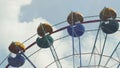 Ferris Wheel of bright color on blue sky background with white clouds Royalty Free Stock Photo