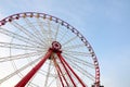 Ferris wheel with cabins on the background of cirrus clouds. A horizontal view