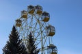 Ferris wheel with cabins closed in winter sunny weather