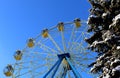 Ferris wheel with cabins closed in winter sunny weather