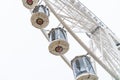 Ferris wheel close-up on gray sky background, traditional fairground attraction