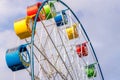 Ferris wheel with colorful cabs against the sky Royalty Free Stock Photo