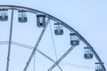 Ferris wheel, detail. Blue sky in the background. Cabins