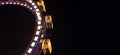 Ferris wheel entertainment object in amusement park at night long exposure circle motion festive lighting on black background Royalty Free Stock Photo