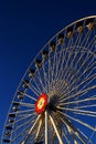 Ferris wheel with flower decoration on blue background Royalty Free Stock Photo