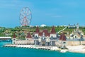 A Ferris wheel on a hill and a fairytale castle on the beach in an amusement park Royalty Free Stock Photo