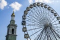 Ferris wheel in historical part of Kyiv. The bell tower of the former Greek monastery at the background. Royalty Free Stock Photo