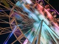 Ferris wheel illuminated at night colorful light motion Royalty Free Stock Photo