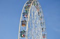 Ferris wheel metall construction. Kazan. Cabins with flags. Blue clear sky