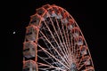 Ferris wheel and the moon. Black sky background. Royalty Free Stock Photo