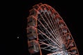 Ferris wheel and the moon. Black sky background. Royalty Free Stock Photo