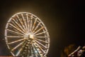 Ferris wheel in motion at the amusement park, night illumination. Long exposure Royalty Free Stock Photo