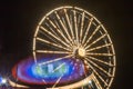 Ferris wheel in motion at the amusement park, night illumination. Long exposure Royalty Free Stock Photo